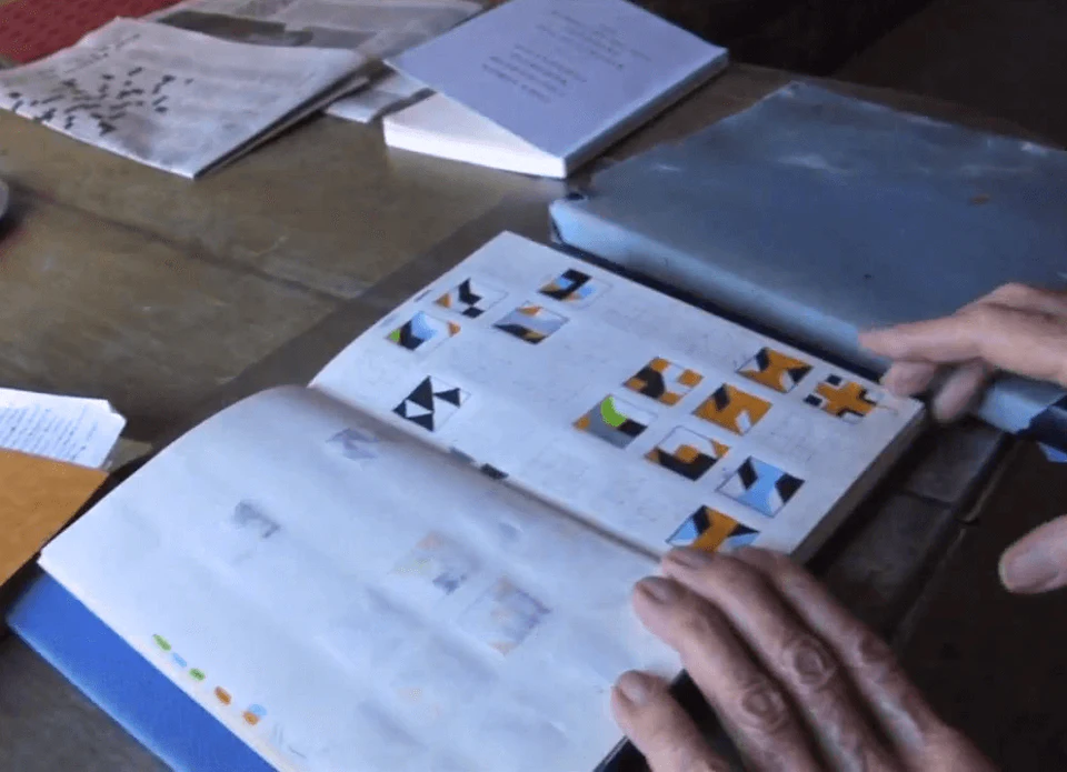 Frederick Hammersley with sketch book of paintings (video screen capture © Vanessa H. Smith)
