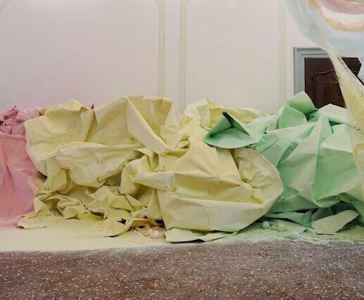 (detail) Karla Black, At Fault , 2011, cellophane, paint, sellotape, plaster powder, powder paint, sugar paper, chalk, bath bombs, ribbon, wood, dimensions variable (courtesy of the artist)
